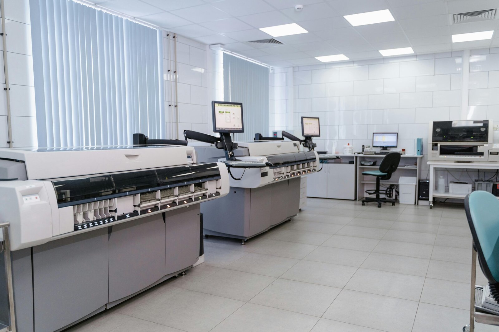 Spacious laboratory interior featuring state-of-the-art machines and computers for research purposes.